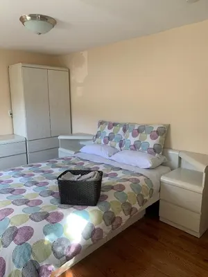 a bedroom with a bed with a purse on it at Cozy1B1B W Private Entrance in Jericho
