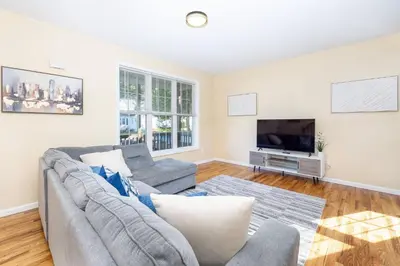 a living room with a couch and a tv at Bright & Cozy Stay in the Heart of Hartford in Hartford