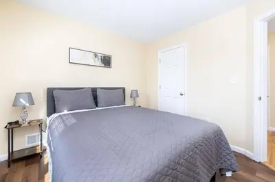 a bedroom with a bed with a gray blanket at Bright & Cozy Stay in the Heart of Hartford in Hartford