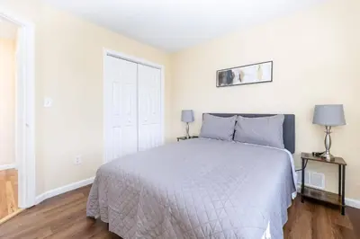 a white bedroom with a bed and a window at Bright & Cozy Stay in the Heart of Hartford in Hartford