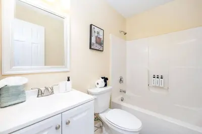 a bathroom with a toilet and a sink and a mirror at Bright & Cozy Stay in the Heart of Hartford in Hartford