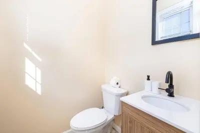 a bathroom with a white toilet and a sink at Bright & Cozy Stay in the Heart of Hartford in Hartford