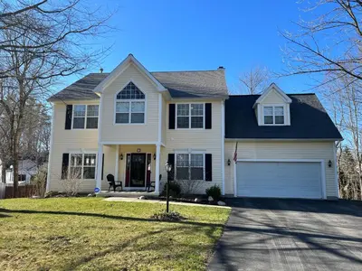 a white house with a black roof at Saratoga Getaway in Saratoga Springs