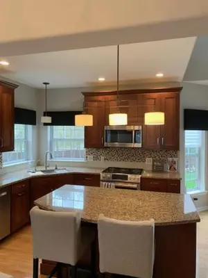 a kitchen with a island with chairs and a counter top at Saratoga Getaway in Saratoga Springs