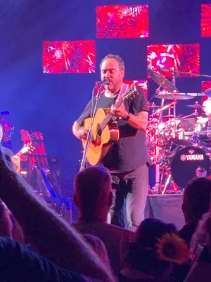 a man playing a guitar on a stage at Saratoga Getaway in Saratoga Springs