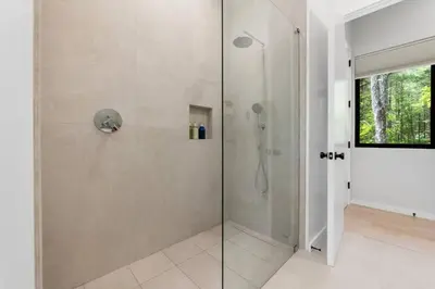 a shower with a glass door in a bathroom at Modern Family Retreat in the Catskills Wilderness in Round Top