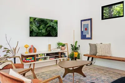a living room with a table and a couch at Modern Family Retreat in the Catskills Wilderness in Round Top