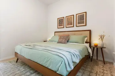 a bedroom with a large bed with two pillows at Modern Family Retreat in the Catskills Wilderness in Round Top