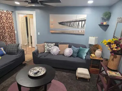 a living room with a couch and a pier at Hidden and comfortable home away from home in Manchester