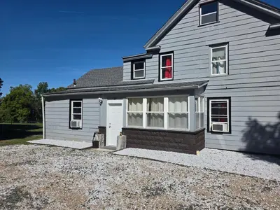 a house with a white garage and a driveway at Hidden and comfortable home away from home in Manchester