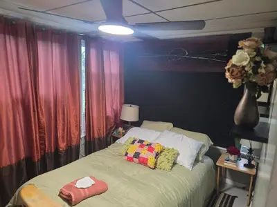 a bedroom with a bed with pillows on it at Hidden and comfortable home away from home in Manchester