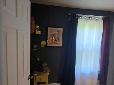 a room with a blue curtain and a window at Hidden and comfortable home away from home in Manchester
