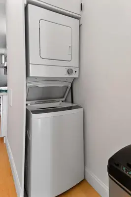 a computer monitor sitting on top of a refrigerator at Spacious 3Bedroom with AC near McCarren Park Brooklyn Stay in Brooklyn