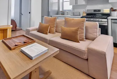 a living room with a couch and a table at Spacious 3Bedroom with AC near McCarren Park Brooklyn Stay in Brooklyn