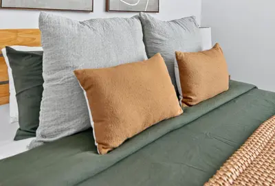 a bunch of pillows sitting on a couch at Spacious 3Bedroom with AC near McCarren Park Brooklyn Stay in Brooklyn