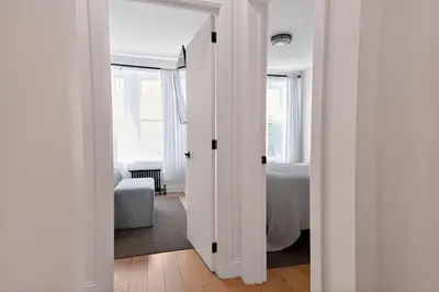 a white room with a door leading to a bedroom at Spacious 3Bedroom with AC near McCarren Park Brooklyn Stay in Brooklyn