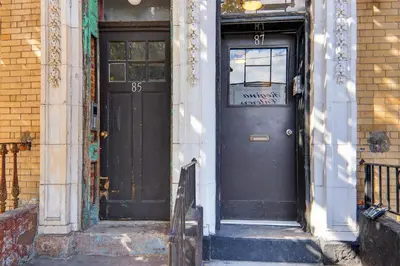 a black door on the side of a building at Spacious 3Bedroom with AC near McCarren Park Brooklyn Stay in Brooklyn