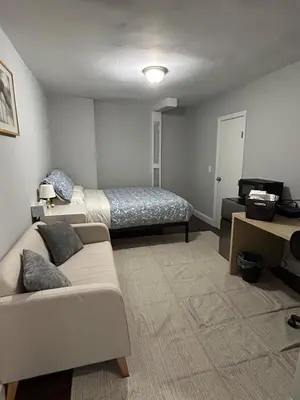 a living room with a couch and a bed at Roslyn Room 2 Private Entrance and Bathroom in Roslyn