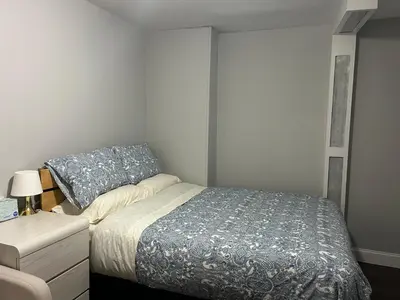 a small bedroom with a bed and a nightstand and a bed sidx sidx sidx at Roslyn Room 2 Private Entrance and Bathroom in Roslyn