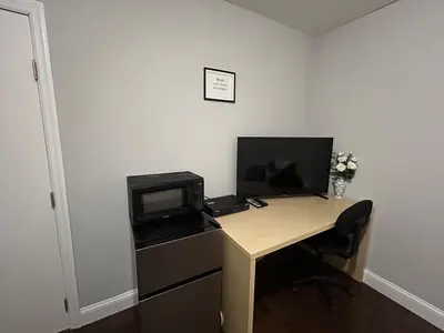 a desk with a microwave and a computer on it at Roslyn Room 2 Private Entrance and Bathroom in Roslyn