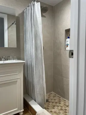 a bathroom with a shower curtain and a sink at Roslyn Room 2 Private Entrance and Bathroom in Roslyn