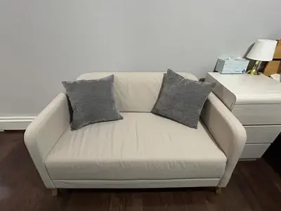 a white couch with two pillows on it in a living room at Roslyn Room 2 Private Entrance and Bathroom in Roslyn
