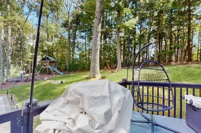 a chair and a swing on a porch with a playground at Blue Mountain Crossing in East Stroudsburg