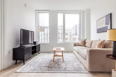 a living room with a couch and a tv at Blueground Alphabet City rooftop nr Tompkins Square Park NYC-2057 in New York