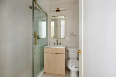 a bathroom with a toilet and a sink and a shower at Blueground Greenpoint view nr McGolrick Park NYC-2071 in Brooklyn