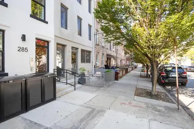 a sidewalk in front of a building with a tree at Blueground Greenpoint view nr McGolrick Park NYC-2071 in Brooklyn
