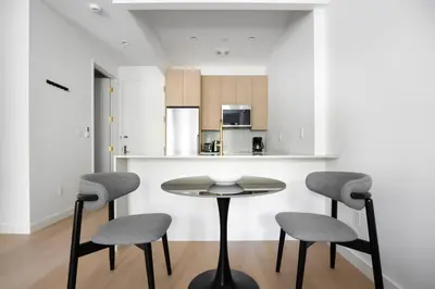 a small kitchen with a table and two chairs at Blueground Greenpoint view nr McGolrick Park NYC-2071 in Brooklyn