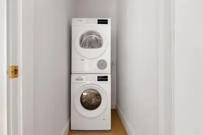 a washing machine and a dryer in a room at Blueground Lincoln Square view nr Central Park NYC-2065 in New York