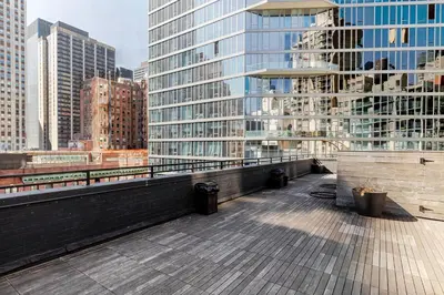 a balcony with a view of a city with tall buildings at Blueground Midtown East rooftop nr Grand Central NYC-2069 in New York