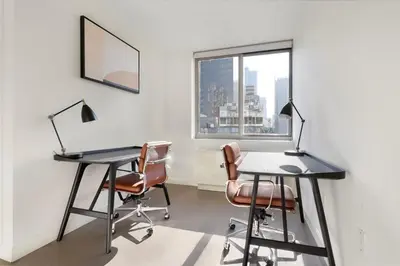 an office with two desks and two chairs and a window at Blueground Hells Kitchen fitness center nr Hudson River Park NYC-2086 in New York