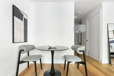 a dining room with a table and four chairs at Blueground Yorkville pool nr Carl Schurz Park NYC-2093 in New York