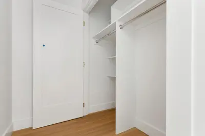 an empty closet with white walls and wooden floors at Blueground Yorkville pool nr Carl Schurz Park NYC-2093 in New York