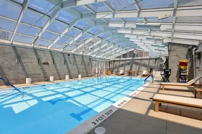 a large swimming pool with a glass ceiling at Blueground Yorkville pool nr Carl Schurz Park NYC-2093 in New York