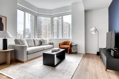 a living room with a couch and a tv at Blueground Lincoln Square fitness center nr Riverside Park NYC-846 in New York