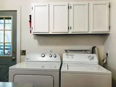 a kitchen with a stove and white cabinets at Sunny & spacious pied-à-terre by Union & Proctors! in Schenectady