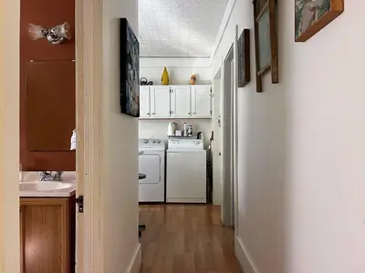 a small kitchen with white appliances and a sink at Sunny & spacious pied-à-terre by Union & Proctors! in Schenectady