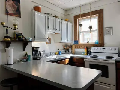 a kitchen with white cabinets and a counter top at Sunny & spacious pied-à-terre by Union & Proctors! in Schenectady