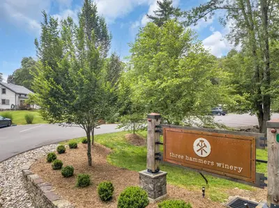 a sign at the entrance to a house with trees at A perfect couples fall getaway in Hawley