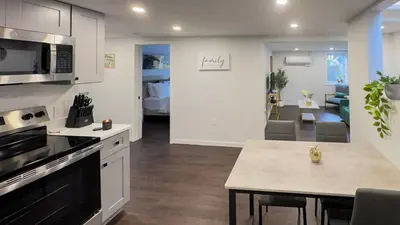 a kitchen and living room with a table and a room with a bed at Modern Apartment Near Tweed -Yale -New Haven in New Haven