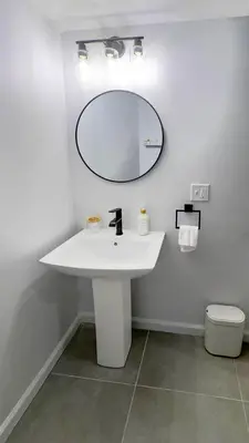 a bathroom with a white sink and a mirror at Modern Apartment Near Tweed -Yale -New Haven in New Haven