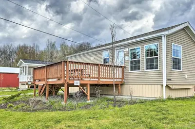 a house with a deck on the side of it at Forest Hideout Cottage Close to Camps and Ski Resorts in Pleasant Mount
