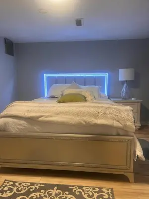 a bed with a blue headboard in a bedroom at Spacious Family-friendly Apartment in New Haven