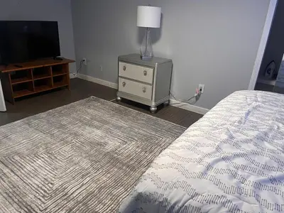 a bedroom with a bed and a dresser with a television at Spacious Family-friendly Apartment in New Haven