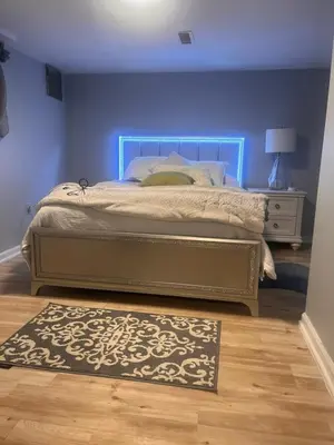 a bedroom with a bed with a blue wall at Spacious Family-friendly Apartment in New Haven