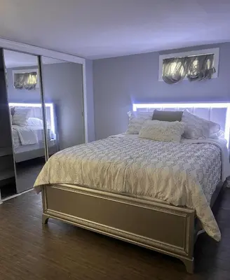 a bedroom with a large bed and a mirror at Spacious Family-friendly Apartment in New Haven