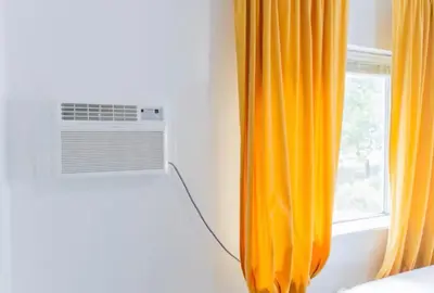 an orange curtain in a room with a window at Bright 1-Bedroom Loft in Converted Garage with Private Entrance in New Rochelle